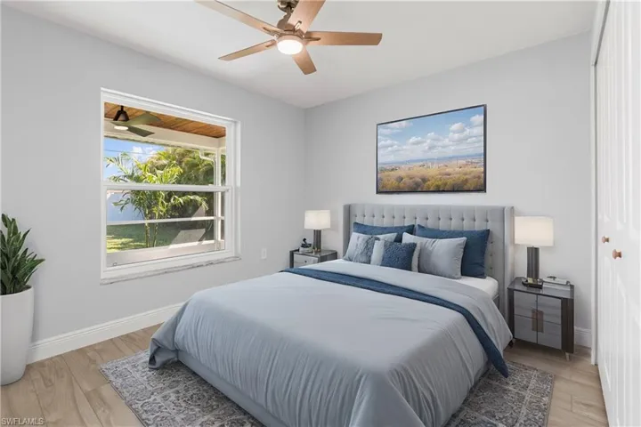 Bedroom with ceiling fan and light hardwood / wood-style floors