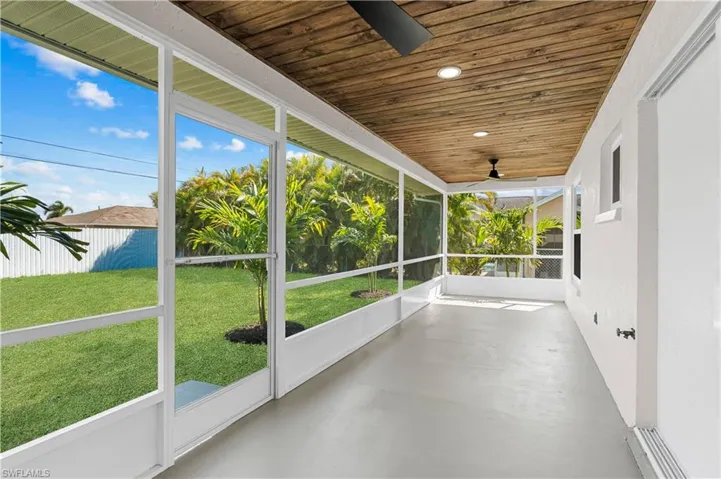 Unfurnished sunroom with wood ceiling and ceiling fan
