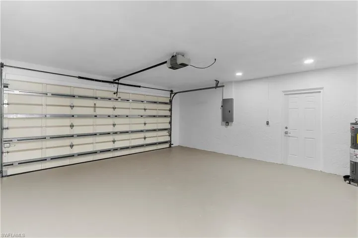 Garage with a garage door opener and electric panel