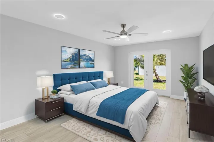 Bedroom featuring light hardwood / wood-style flooring, access to outside, french doors, and ceiling fan