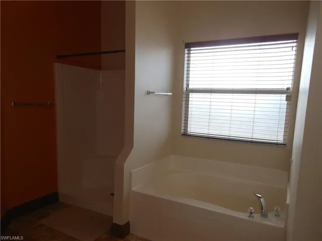 Bathroom with a bath and a stall shower