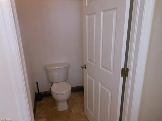 Bathroom featuring toilet and baseboards