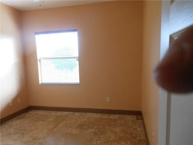 Empty room featuring baseboards