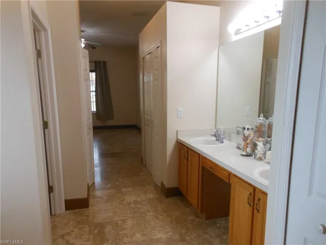 Bathroom with double vanity and a ceiling fan