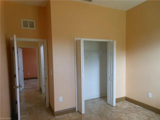 Unfurnished bedroom featuring baseboards and a closet