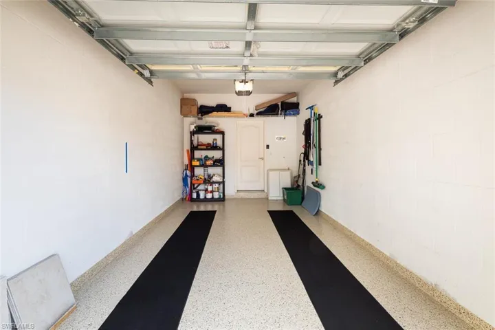Garage with concrete block wall and a garage door opener