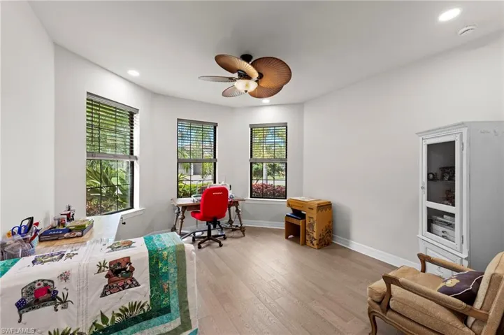 Office area featuring recessed lighting, hardwood / wood-style floors, and a ceiling fan