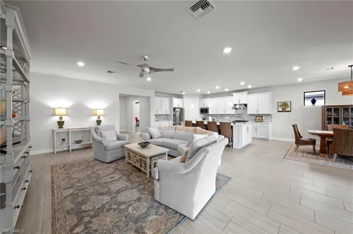 Living room with wood tiled floors, recessed lighting, and ceiling fan
