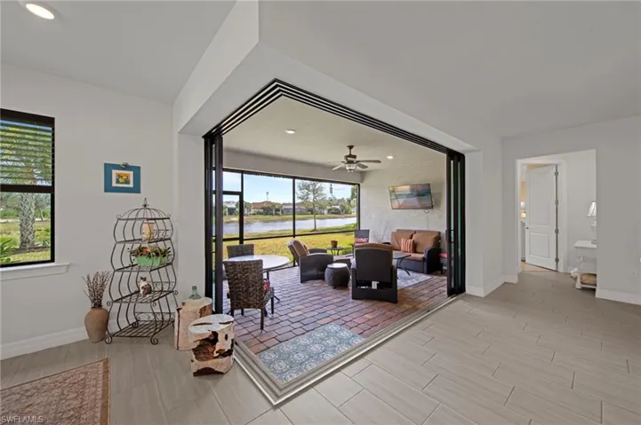 Living area featuring a ceiling fan, a sunroom, recessed lighting, and wood tiled floors