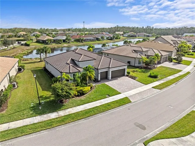 Aerial view of residential area featuring a large body of water
