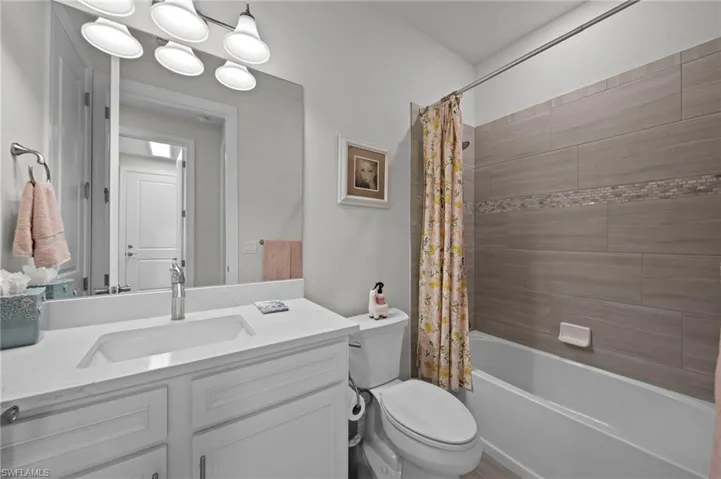 Full bathroom featuring shower / tub combo and vanity