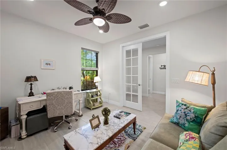 Home office with a ceiling fan, recessed lighting, wood finish floors, and french doors