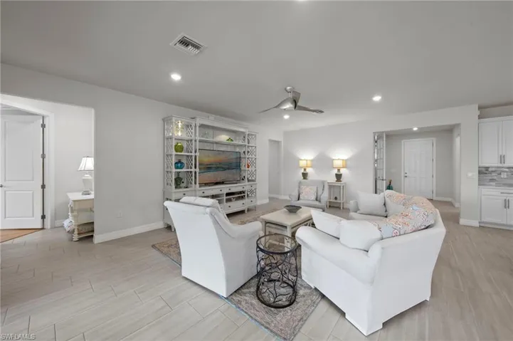 Living room featuring ceiling fan, recessed lighting, and wood tiled floors