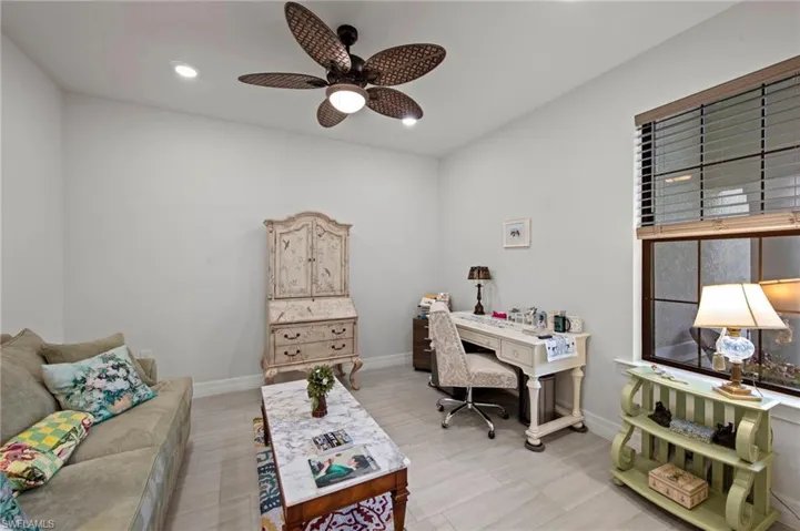 Office space with a ceiling fan and recessed lighting