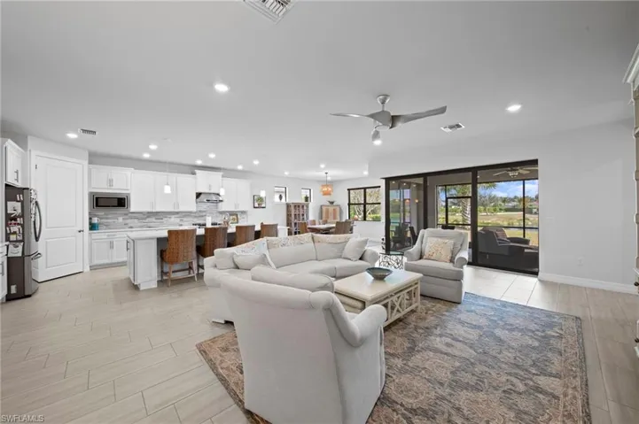 Living room with recessed lighting and ceiling fan