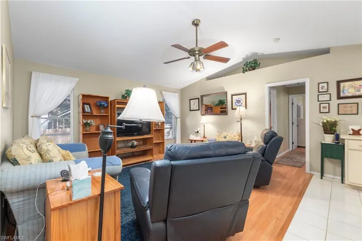 Kitchen featuring a sink, light tile patterned floors, a kitchen island with sink, and plenty of natural light