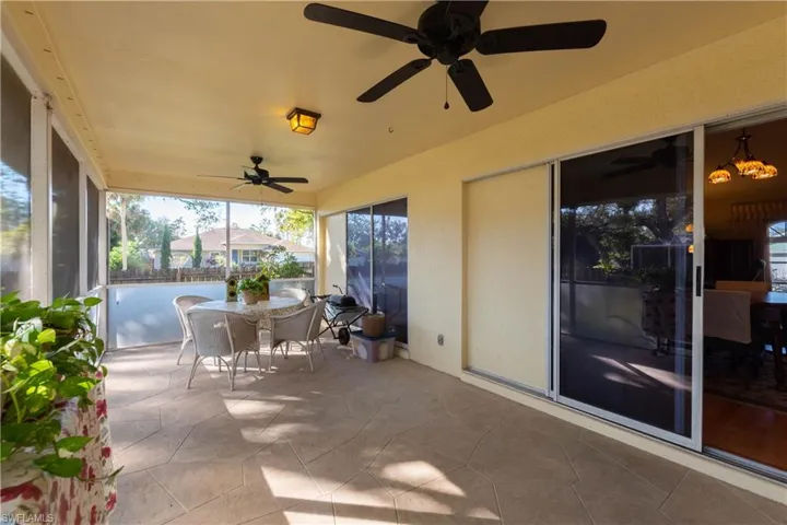 Sunroom / solarium with a wealth of natural light and ceiling fan