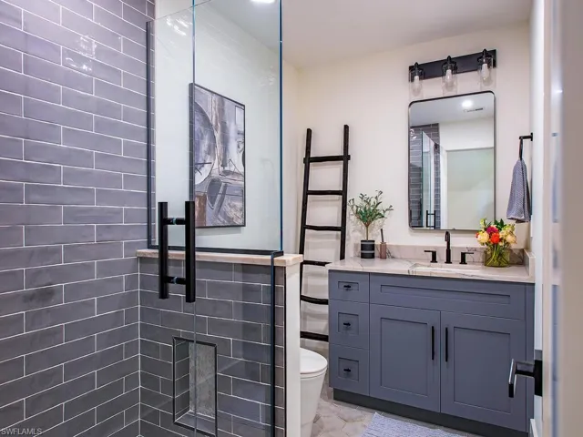 Bathroom with a stall shower and vanity