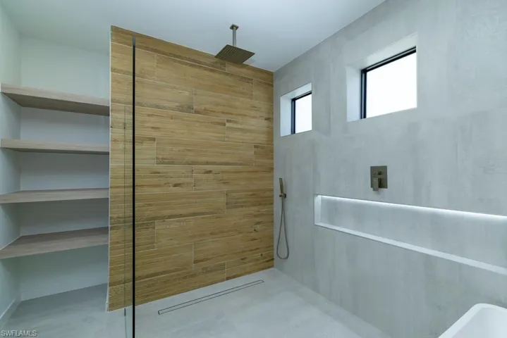 Spare room featuring concrete floors, a ceiling fan, a tray ceiling, and recessed lighting