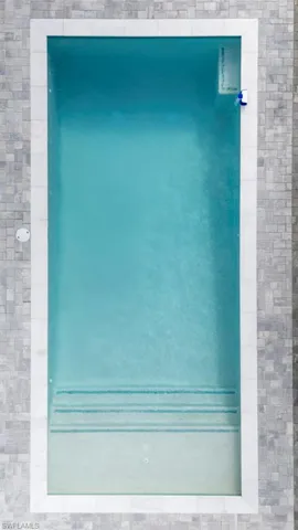 View of swimming pool featuring a patio and a fenced backyard