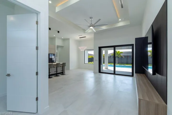 Unfurnished bedroom featuring concrete flooring, a closet, recessed lighting, and a ceiling fan
