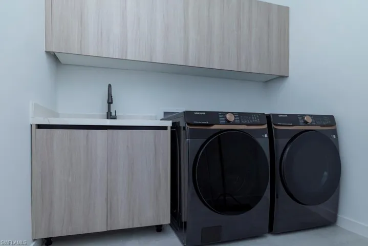 Laundry room featuring washing machine and clothes dryer