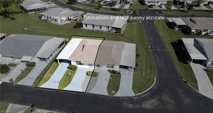 Aerial view of property and surrounding area with nearby suburban area