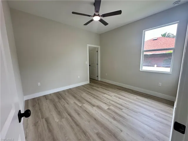 Empty room with light wood-type flooring and a ceiling fan