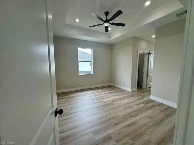 Empty room featuring light wood-style flooring and a ceiling fan