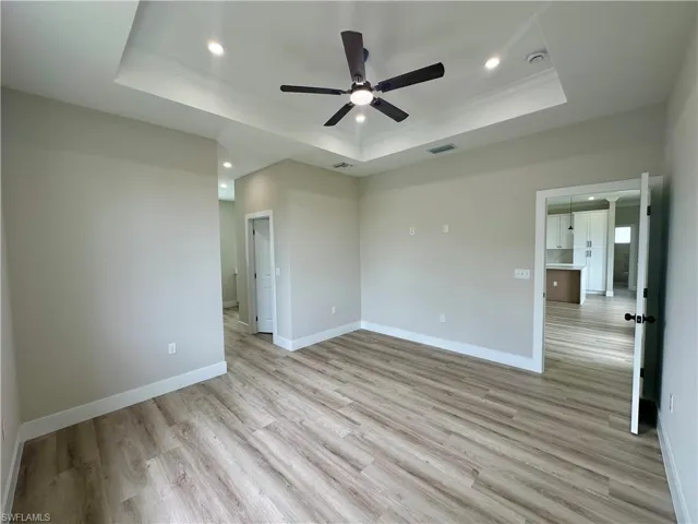 Unfurnished room with wood finished floors and ceiling fan
