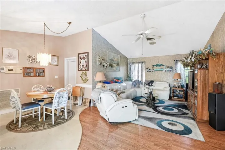 VIRTUALLY STAGED Vaulted ceiling with ceiling fan, wood-finish flooring, and built-in wood cabinetry
