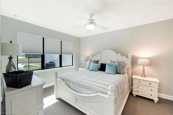 Bedroom with dark colored carpet and ceiling fan