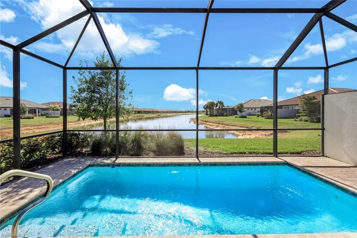 Swimming pool with a sunroom, a lanai, and a yard