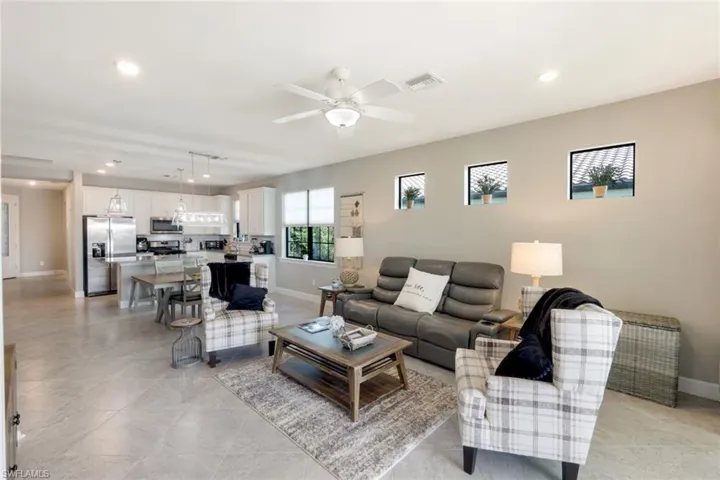 Living area featuring recessed lighting and a ceiling fan