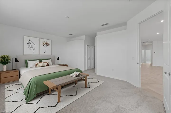 Bedroom with light colored carpet and recessed lighting