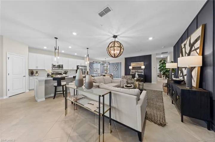 Living area featuring recessed lighting, a chandelier, and light tile patterned flooring