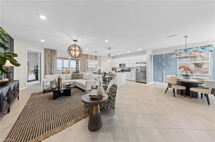Living area with a chandelier, recessed lighting, and light tile patterned flooring