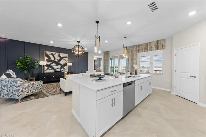 Kitchen featuring open floor plan, recessed lighting, light stone countertops, pendant lighting, and dishwasher