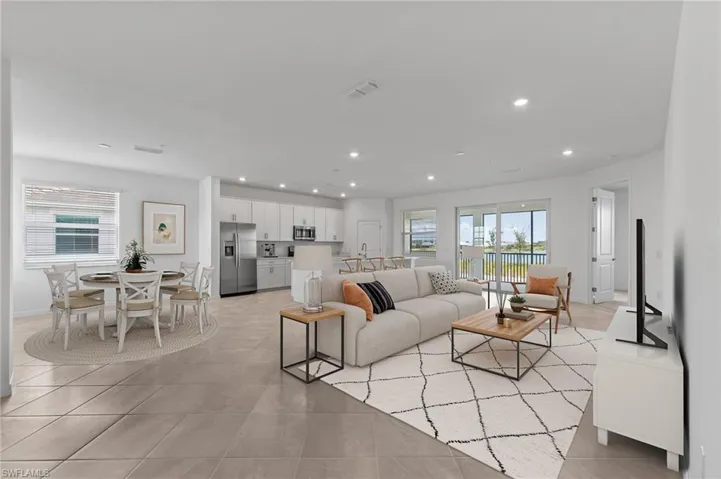 Living area with healthy amount of natural light, recessed lighting, and light tile patterned floors