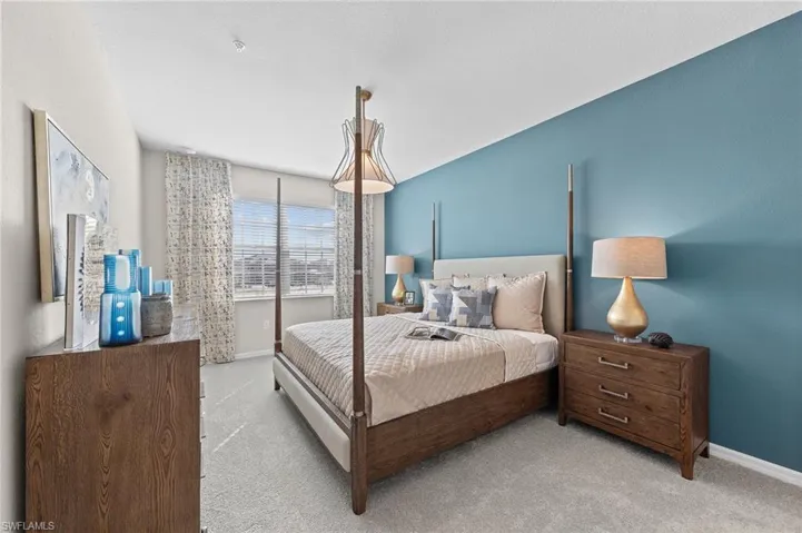 Bedroom featuring carpet floors and baseboards