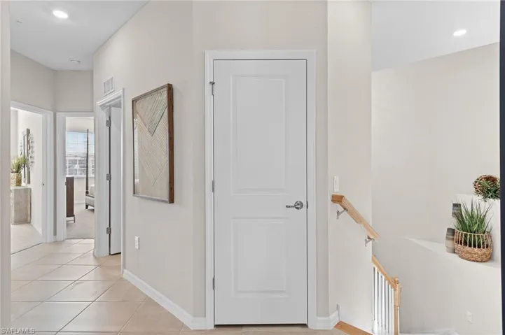Hall featuring recessed lighting and light tile patterned flooring