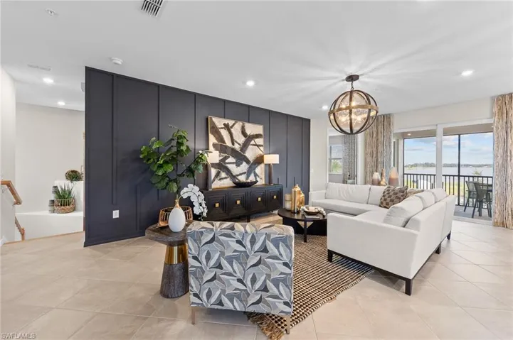 Living area with a chandelier, recessed lighting, and light tile patterned floors