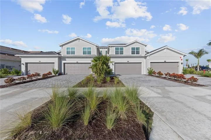 View of front of home with decorative driveway and an attached garage