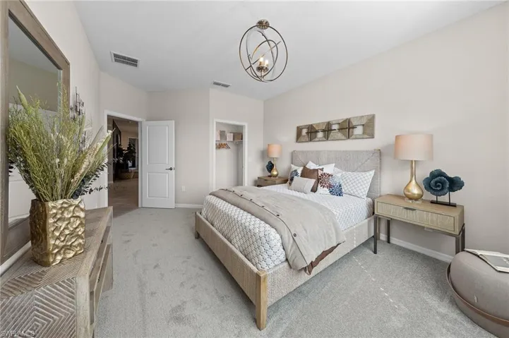 Bedroom featuring carpet, a chandelier, and a closet