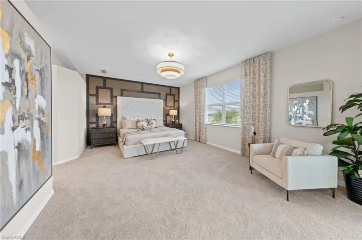 Carpeted bedroom with baseboards and an accent wall