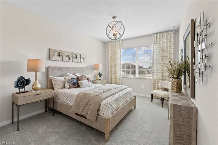 Bedroom with carpet and a chandelier