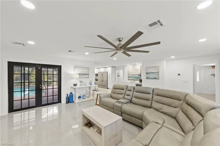 Living area with french doors, recessed lighting, a ceiling fan, and light tile patterned flooring