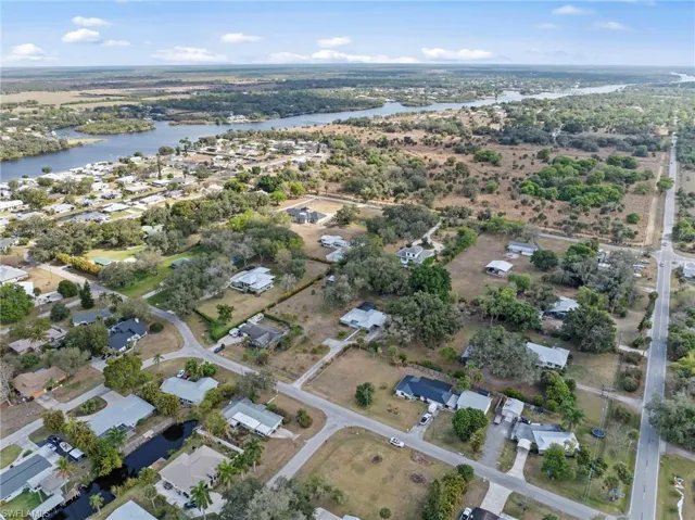 Aerial view of property and surrounding area with nearby suburban area