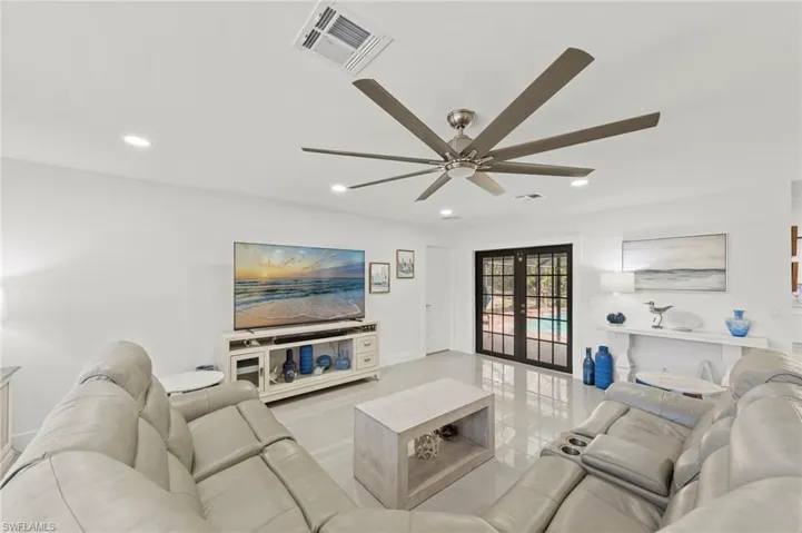 Living room featuring french doors, recessed lighting, ceiling fan, and light tile patterned flooring