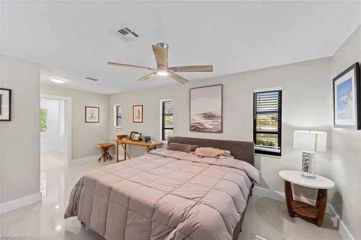 Bedroom featuring multiple windows and a ceiling fan